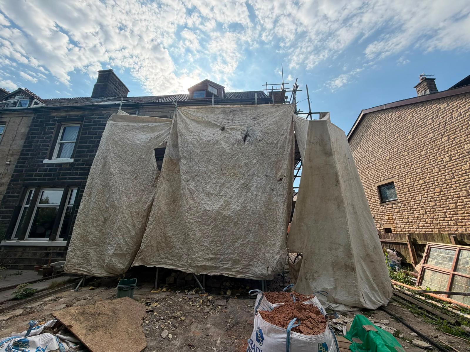 Rear elevation fully sheeted and contained before blasting