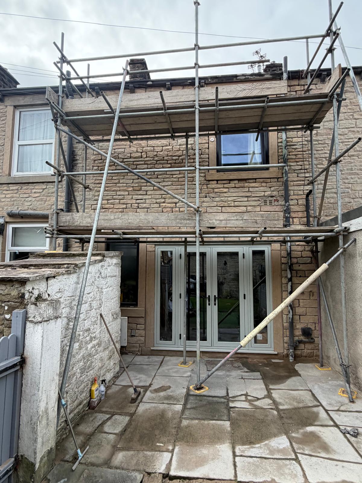 Scaffolded rear stone elevation during sandblasting in Barrowford