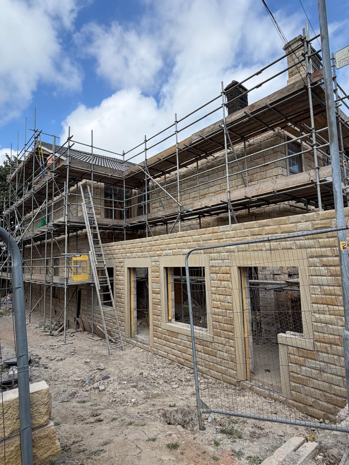 Full elevation mid-clean, contrast between blasted and soiled stone