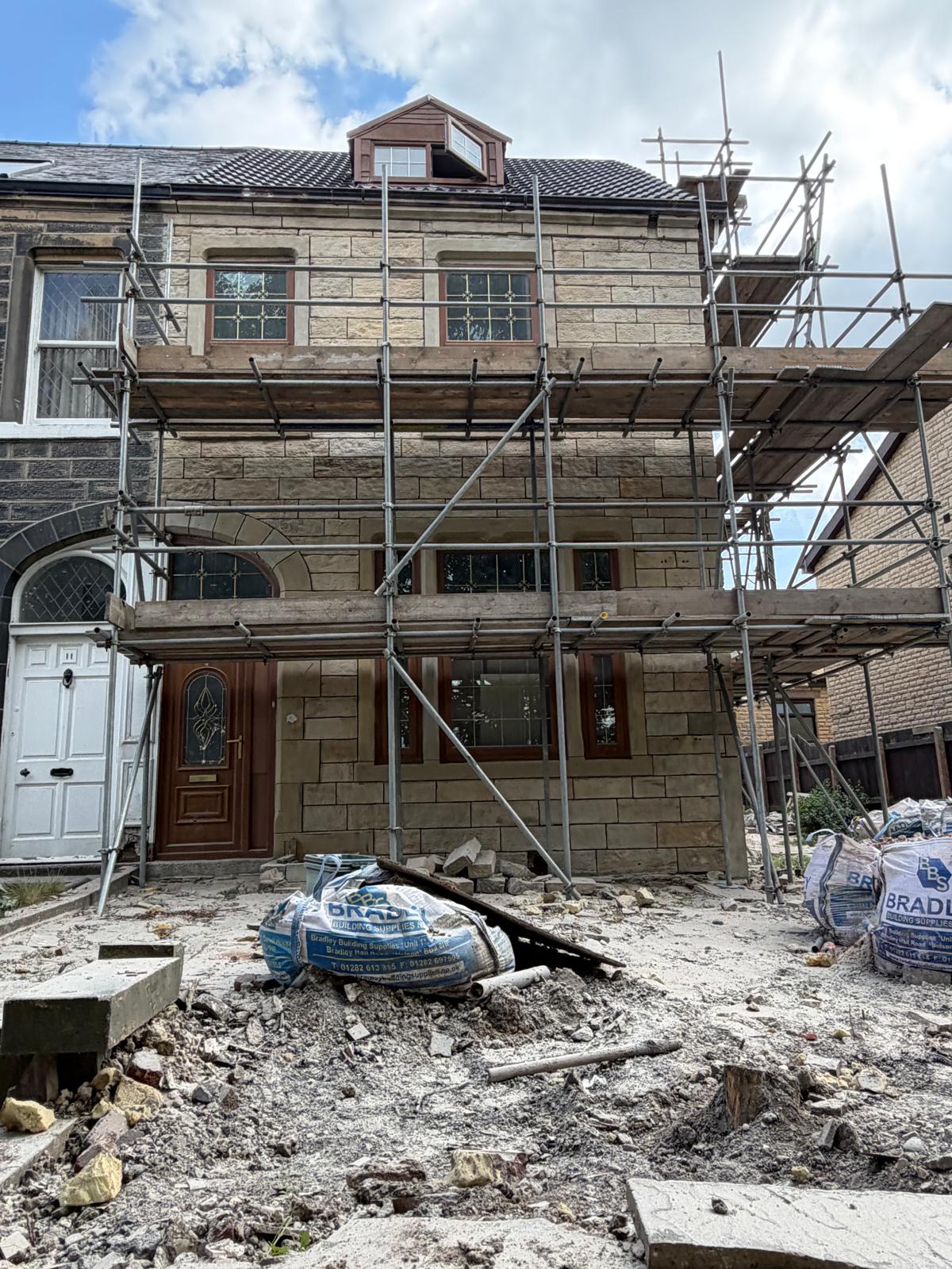 Completed frontage — clean sandstone, crisp window heads